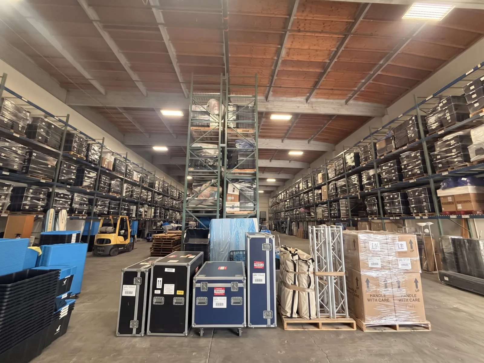 Booth cases and palletized display materials organized in a warehouse for the next show