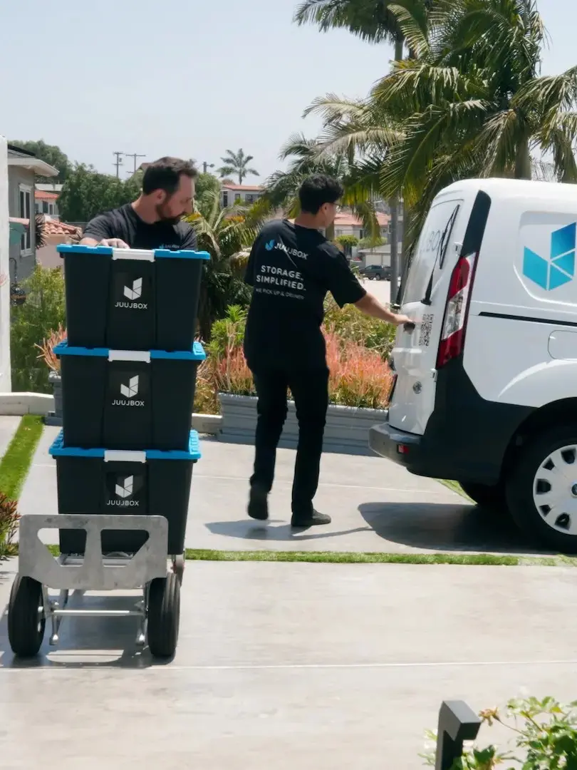 Juujbox team members loading storage bins into service van in San Diego
