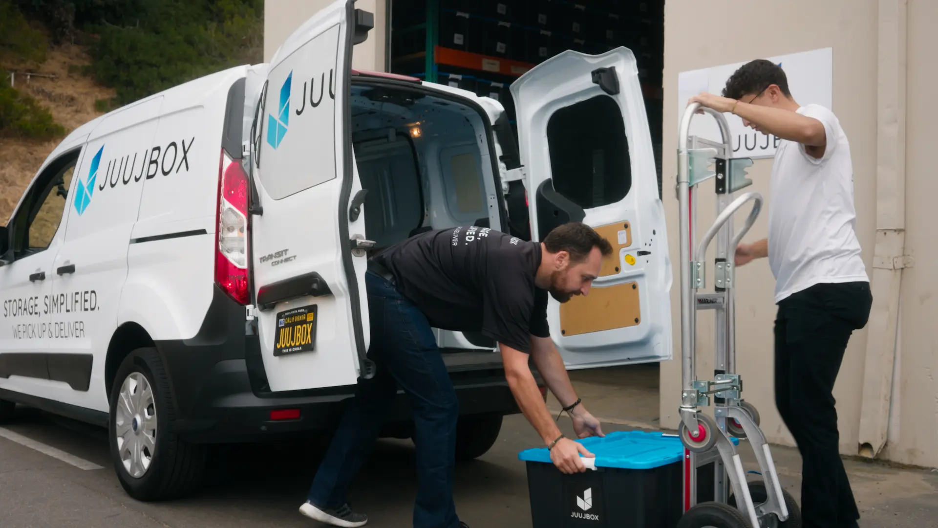 Juujbox team members loading storage bins into service van in San Diego