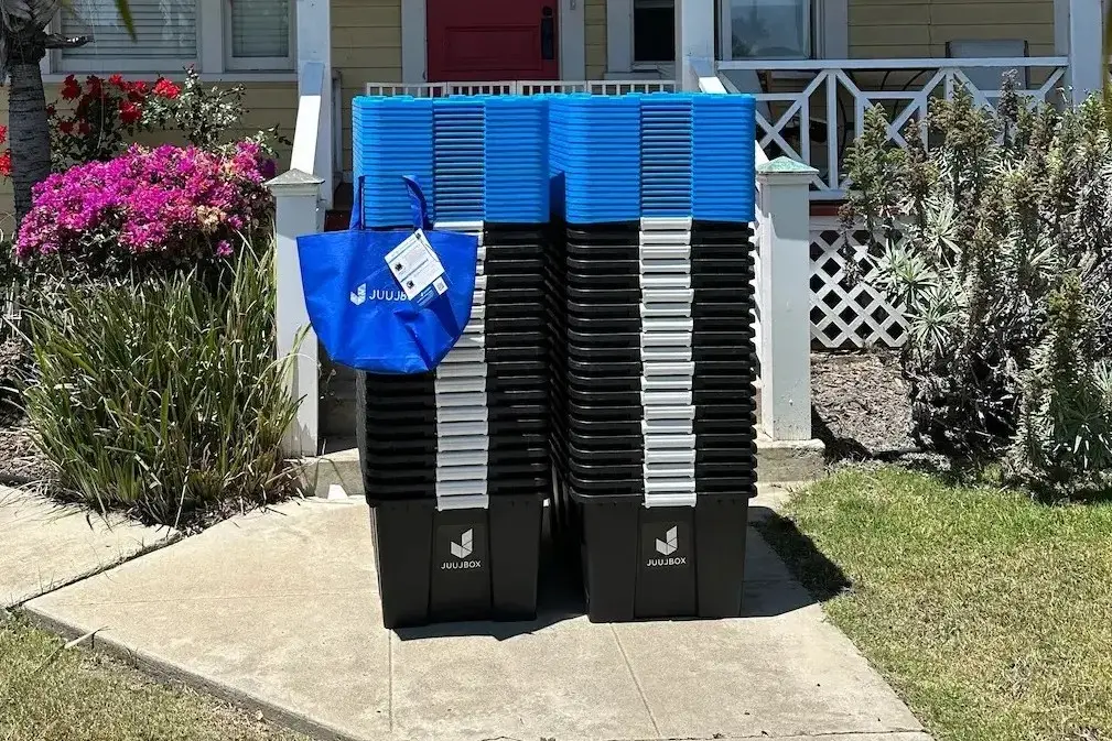 Neatly stacked Juujbox moving bins delivered to a San Diego home