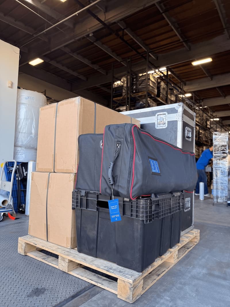 One Standard Event Kit staged for storage with road cases, banners, and boxes on a pallet